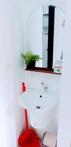 a bathroom with a white sink and a red stool at 203 Casa de Rany in Daro