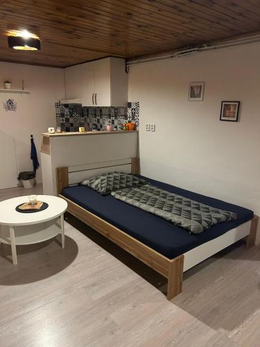 a bed and a table in a room at U krbu in Jindřichovice