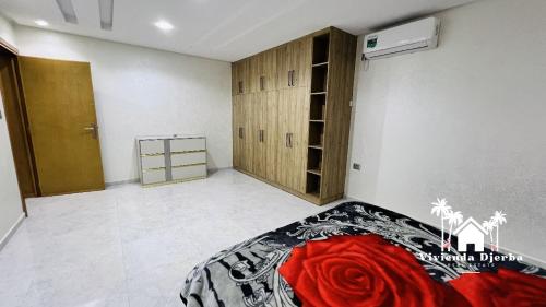 a bedroom with a bed in a room with a closet at Djerba Villa De Luxe in Houmt Souk