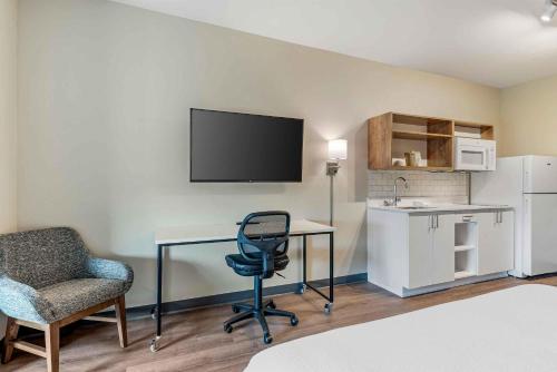 a room with a desk and a chair and a television at Extended Stay America Premier Suites - Austin - Kyle in Kyle
