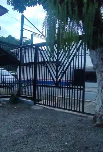 a black gate with a tree in front of it at Cabinas Doña Alicia in Quepos
