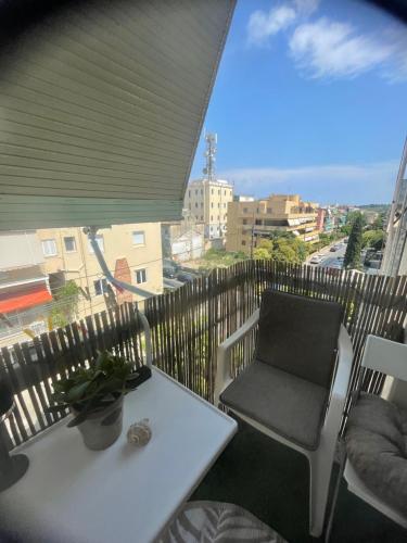 a table and chair on a balcony with a view at Casa di Irene in Agios Rokkos