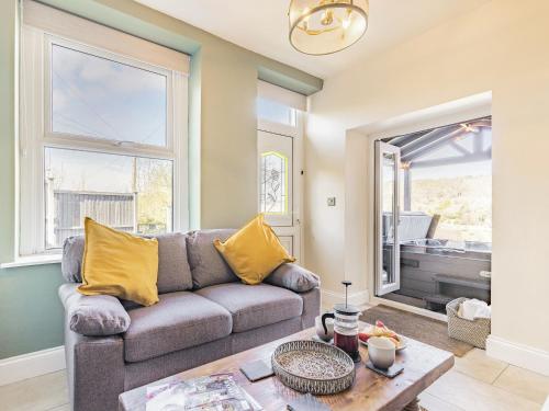 a living room with a couch and a table at Spa Cottage in Bakewell