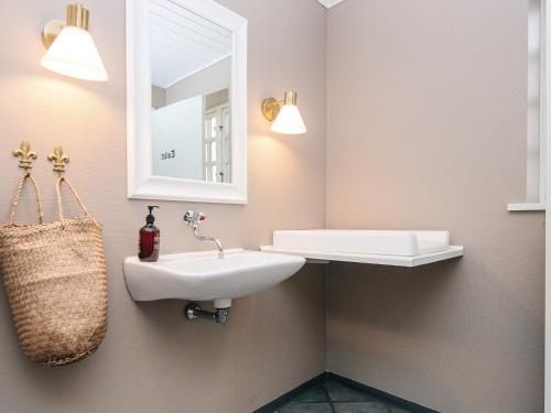 a bathroom with a sink and a mirror at 4 person holiday park home in Give in Give