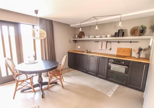 a kitchen with a table and chairs in a room at Skjálfandi in Húsavík