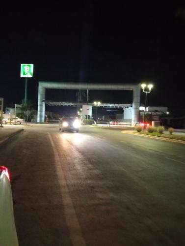 a car driving down a street at night at Zona TSM 2 habitaciones 2 camas 1 sofa cama circuito privado casa completa con todas las comodidades para trabajar o descansar en familia in La Flor