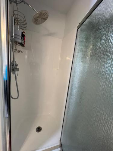 a shower with a glass door in a bathroom at Entire Cozy Apartment with Share Jacuzzi to Enjoy Amazing Views in Halifax