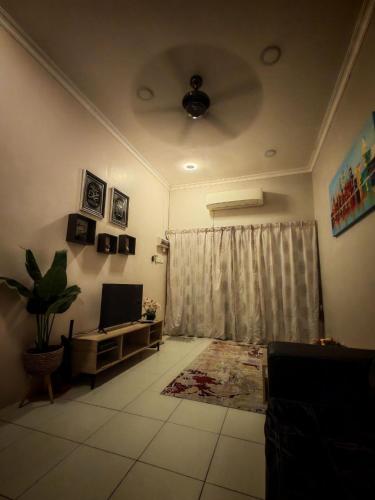 a living room with a couch and a window at Homestay Sakinah No 39 in Tanjung Malim