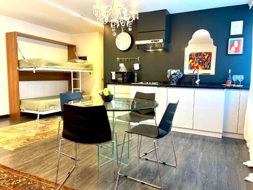 a kitchen and dining room with a glass table and chairs at Ohl House, Boutique Home Stay in Providencia