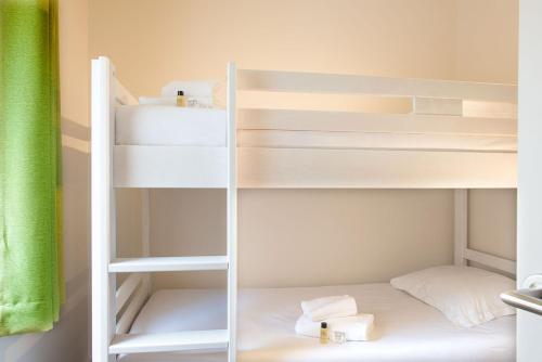 a white bunk bed in a small room at Hôtel Vacances Bleues Delcloy in Saint-Jean-Cap-Ferrat