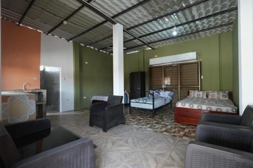 a living room with a bed and a couch at HostaSuites Mijinn in Playas