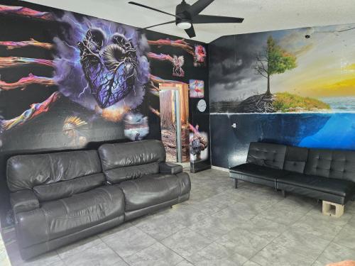 a living room with a couch and a painting on the wall at Shared living NOT A HOTEL in Phoenix