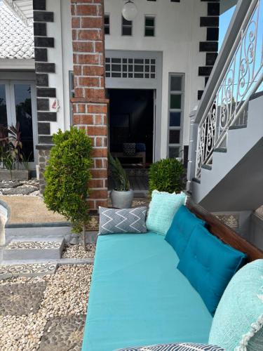 a couch on the front porch of a house at villa Angin in Munggu