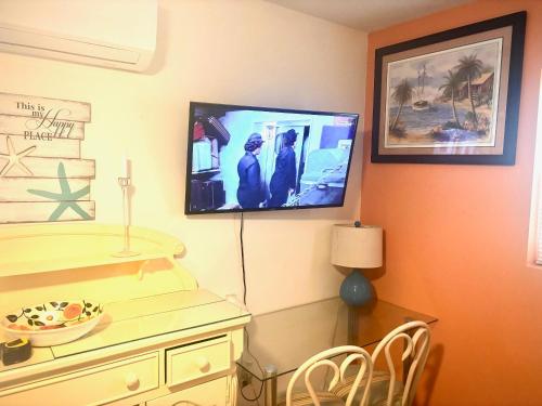 a living room with a tv on the wall at ~ Cozy In-law Apartment Close to Siesta Key ~ in Sarasota