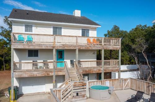 a house with a deck with a hot tub at 1662 - Dune Our Thing in Corolla