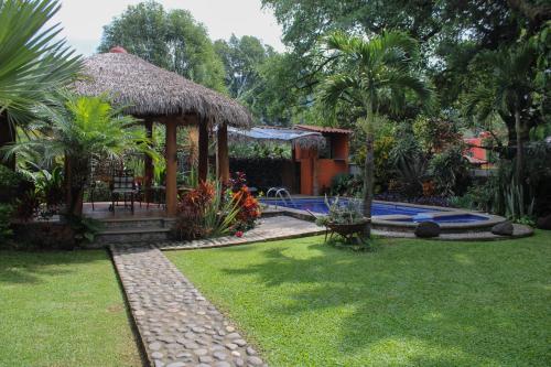 a garden with a gazebo and a swimming pool at Posada Guayacán Tepoztlán in Tepoztlán