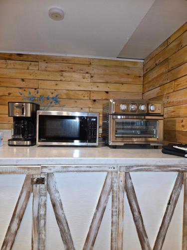 a kitchen with a counter with microwaves and appliances at Rustic Guest Suite in Ucluelet