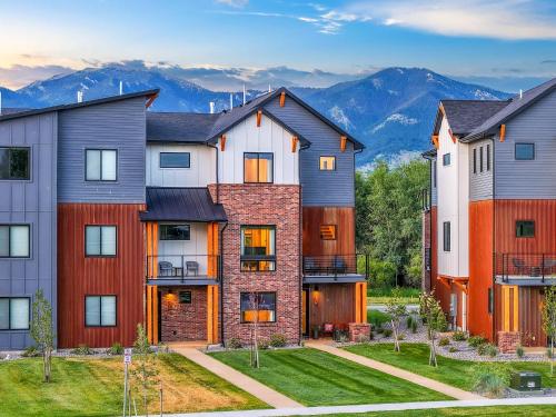 a home with mountains in the background at Pagoda Peaks - Modern Luxury Near Bozeman Beach in Bozeman