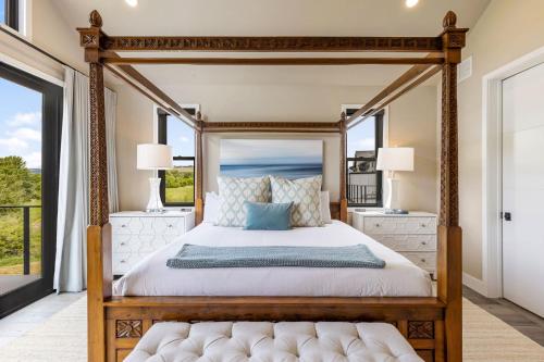 a bedroom with a canopy bed and a window at Pagoda Peaks - Modern Luxury Near Bozeman Beach in Bozeman