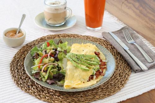 a plate of food with a salad and a drink at Holiday Inn Navojoa by IHG in Navojoa