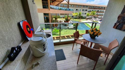 a balcony of a hotel with a table and chairs at Refeições inclusa - Polinesia Resort - Porto de Galinhas - Apartamentos com somente 1 opção de Térreo com Piscina Privativa - Acesso ao Hotel Samoa in Porto De Galinhas