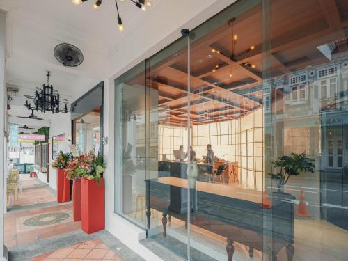 a store front with glass windows and people in a restaurant at A Hotel Chinatown- Stay From 8PM To 9AM in Singapore