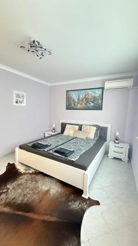 a bedroom with a large bed in a room at Karchevi Apartment in Sveti Vlas