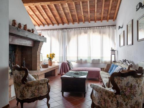 a living room with a couch and a fireplace at Peccioli Family Retreat w Fun in Peccioli