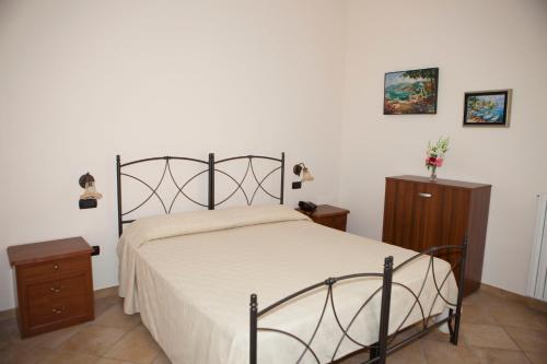 a bedroom with a large bed and a wooden cabinet at Agriturismo da Regina in Tramonti