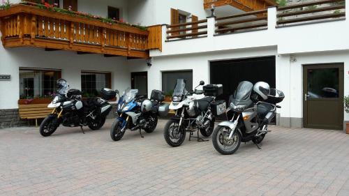 a group of motorcycles parked outside of a building at Aktiv Hotel Schönwald in Nova Levante