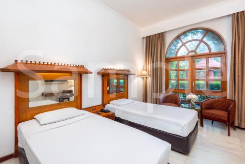 Postel nebo postele na pokoji v ubytování Ashok Country Resort