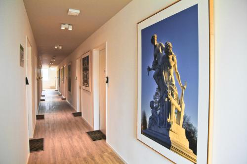 a hallway with a large painting on the wall at Country Inn Suitenhotel in Werder
