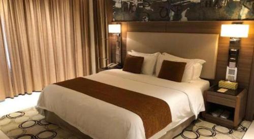 a bedroom with a large bed in a hotel room at Jai Alai Hotel in Macau