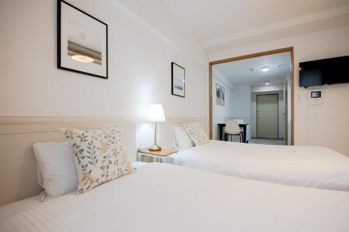 Ένα ή περισσότερα κρεβάτια σε δωμάτιο στο GuestHouse MIYABI