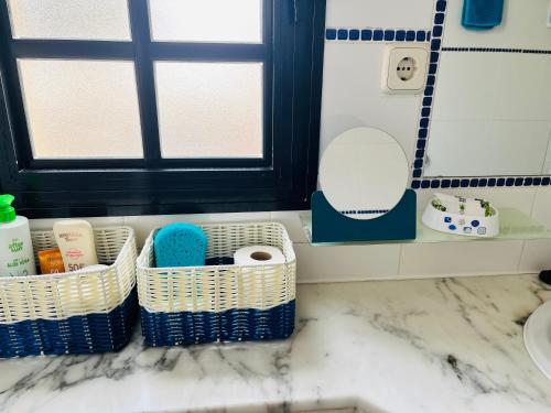 a bathroom with two baskets on a counter at Oasis del Sol in Costa Calma