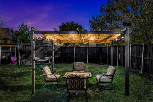 a gazebo with chairs and a table in a yard at Jacuzzi Lakefront Home w/ Game room+play structure in Rockwall