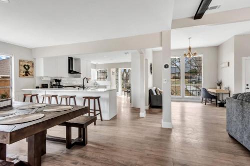 a kitchen and living room with a table and chairs at Jacuzzi Lakefront Home w/ Game room+play structure in Rockwall