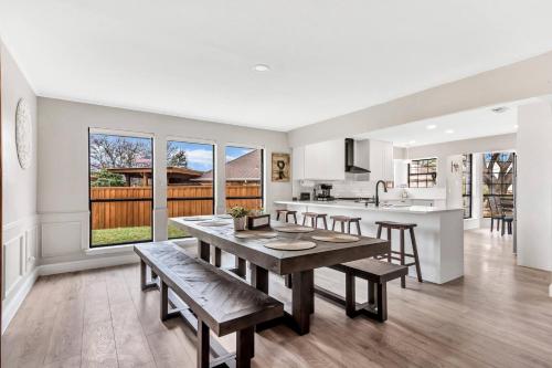 a kitchen and dining room with a table and chairs at Jacuzzi Lakefront Home w/ Game room+play structure in Rockwall