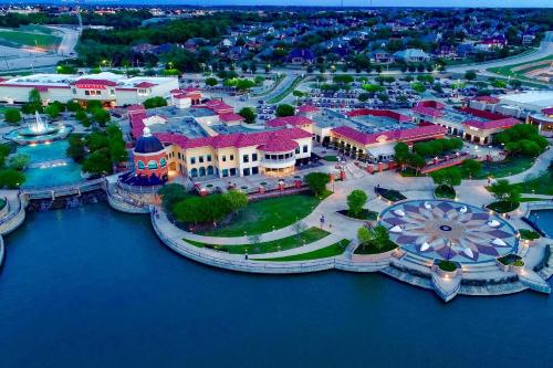 an aerial view of a resort next to the water at Jacuzzi Lakefront Home w/ Game room+play structure in Rockwall