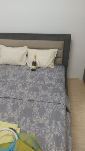 a bed with a bottle of champagne sitting on it at Sofi in Jagodina