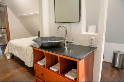 a bathroom with a sink and a bed at Maple Haven Cabin in Maple Falls