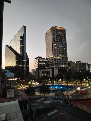 a city skyline at night with tall buildings at Suite Vista Reforma in Mexico City