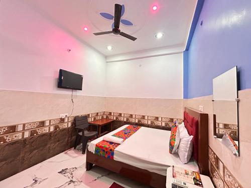 a bedroom with a bed and a ceiling fan at Hotel S!ya Ram Ayodhya Near Ram Janam Bhoomi & Temple - fully Air Conditioned hotel at Prime Location - Parking-Wi-Fi -Lift Facilities - Best Hotel In Ayodhya in Ayodhya