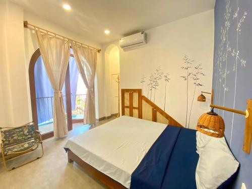 a bedroom with a blue and white bed in a room at VYA homestay Huế in Thôn Lại Thê