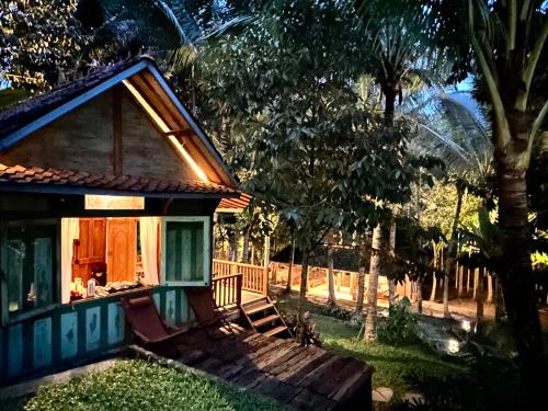 a small house with a window in a yard at The Manikyang Residence in Tabanan
