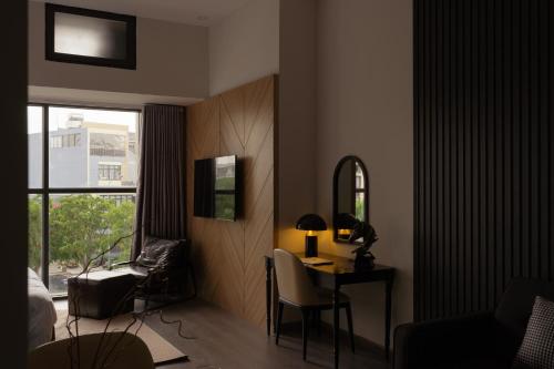 a bedroom with a desk and a chair and a mirror at DingD0ng Suites - The Sun Avenue - Free Pool & Gym in Ho Chi Minh City