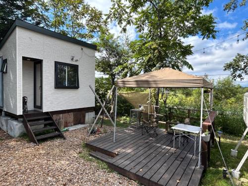 a wooden deck with a tent and a table at niseko kamahale village - Vacation STAY 85808v in Kaributo