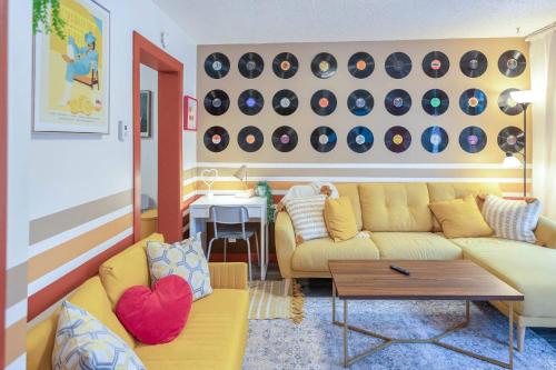 a living room with two couches and a table at Retro Glam in Ramsay Walk to Stampede Grounds in Calgary