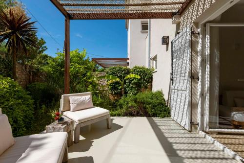 a patio with a chair on the side of a house at Galboka Residence in Nerezine