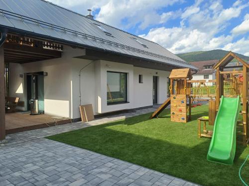 a backyard with a playground with a slide at Chata Studienka 1 in Habovka